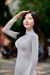 Captivating White Ao Dai: Elegant Vietnamese Girl in a Serene Moment, Timeless Beauty. Image ID: 1000019816.-0
