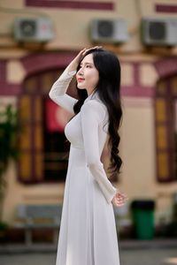 Captivating White Ao Dai: Elegant Vietnamese Girl in a Serene Moment, Timeless Beauty. Image ID: 1000019816.-8